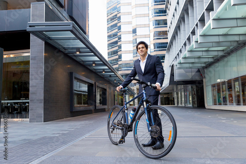 Fototapeta Naklejka Na Ścianę i Meble -  Successful businessman riding bicycle