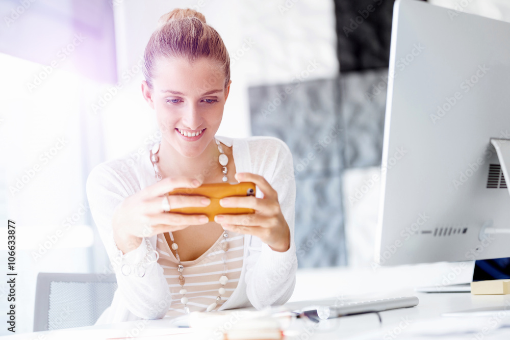 Attractive office worker sitting at desk Attractive office worker sitting at desk