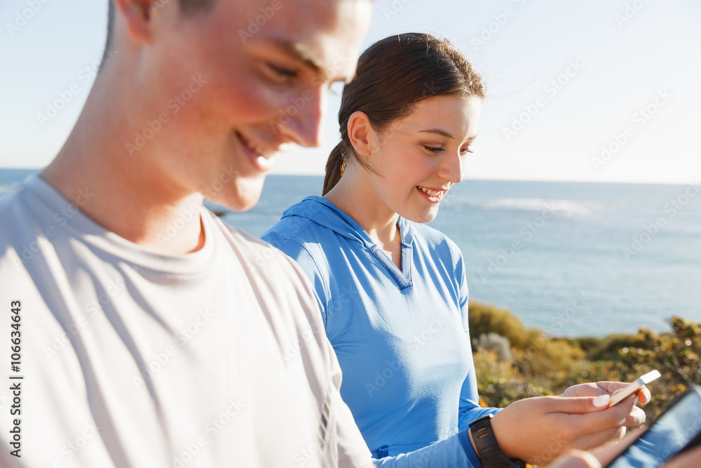 Young couple with smartphones outdoors Young couple with smartphones outdoors
