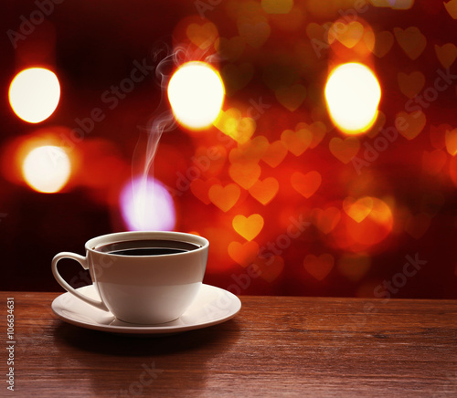 Cup of coffee on table on blured cafe background