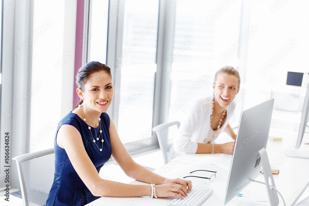 Attractive office worker sitting at desk Attractive office worker sitting at desk