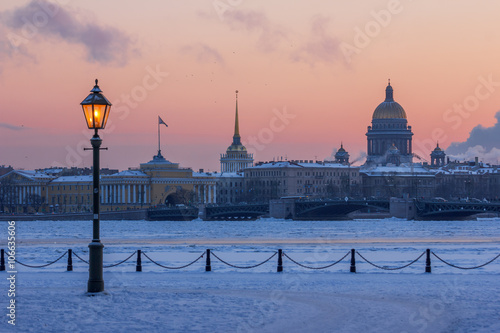 St. Petersburg in the winter. View on architecture of the Admiralty island from the  Hare Island across the frozen Neva frosty evening after sunset