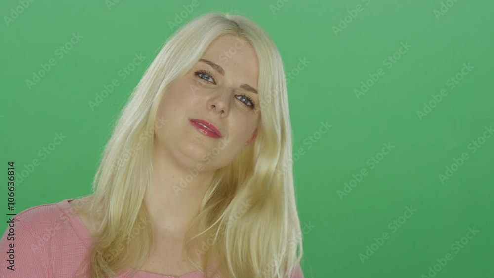 Beautiful blonde woman with blue eyes smiling, on a green screen studio background Beautiful blonde woman with blue eyes smiling, on a green screen studio background