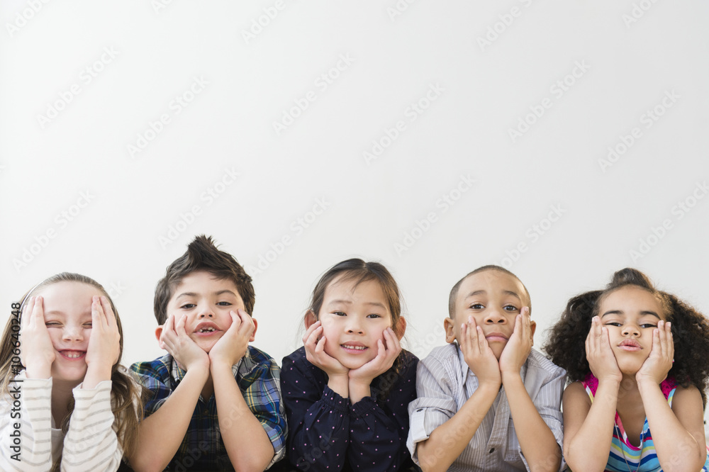 Children resting chins in hands Children resting chins in hands
