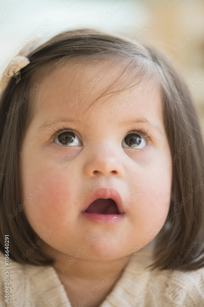 Hispanic toddler with Down syndrome looking up Hispanic toddler with Down syndrome looking up