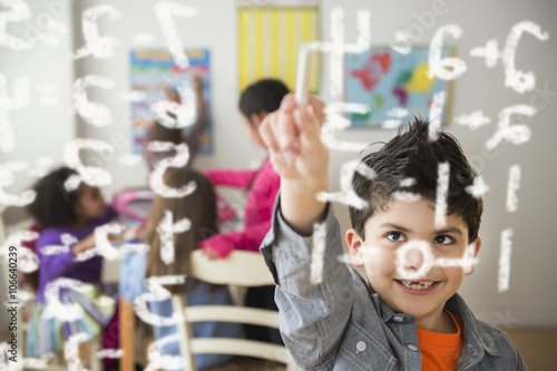 Boy doing math problems in classroom