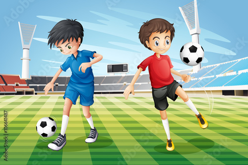 Boys playing soccer in the field