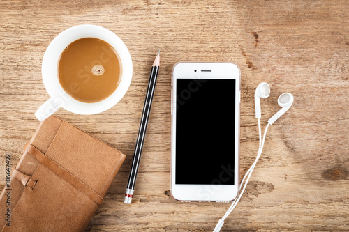 Mobile phone on wood table background, clipping path inside