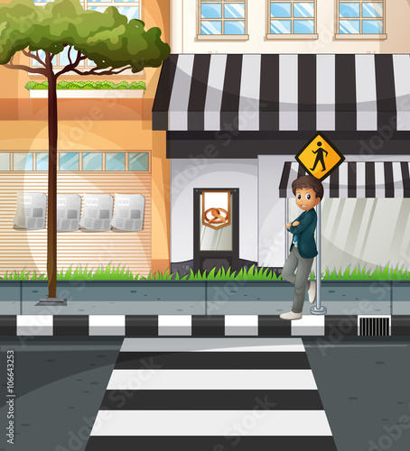 Man waiting at the crossing sign