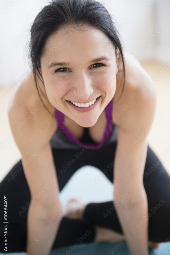 Caucasian woman smiling on yoga mat Caucasian woman smiling on yoga mat