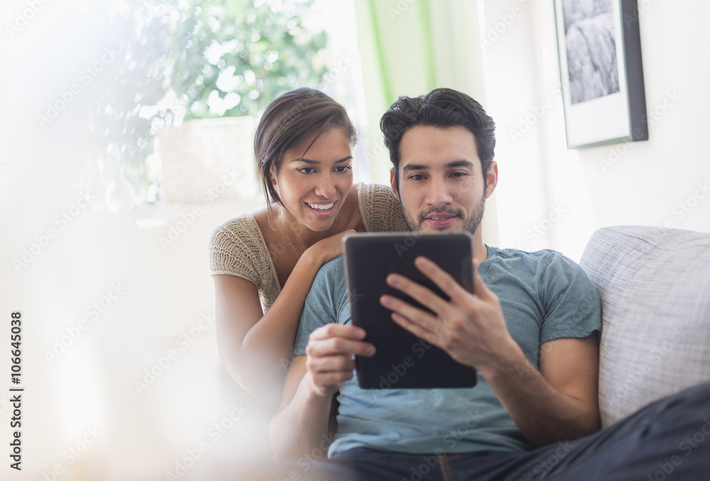 Couple using digital tablet together Couple using digital tablet together