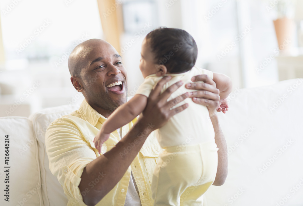 Smiling father playing with baby Smiling father playing with baby