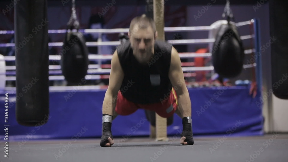 Sports: Man is practicing kick in a boxing gym Sports: Man is practicing kick in a boxing gym