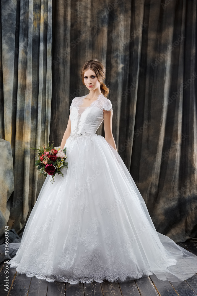 Attractive bride in wedding dress in studio Attractive bride in wedding dress in studio
