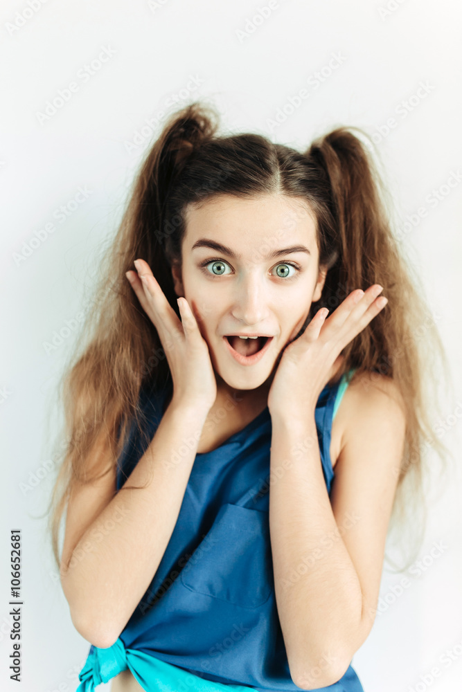 Surprised young girl with pigtails Surprised young girl with pigtails