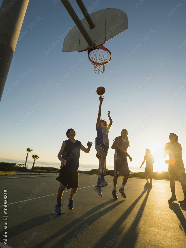 Back lit basketball teams playing on court Stock Photo | Adobe Stock