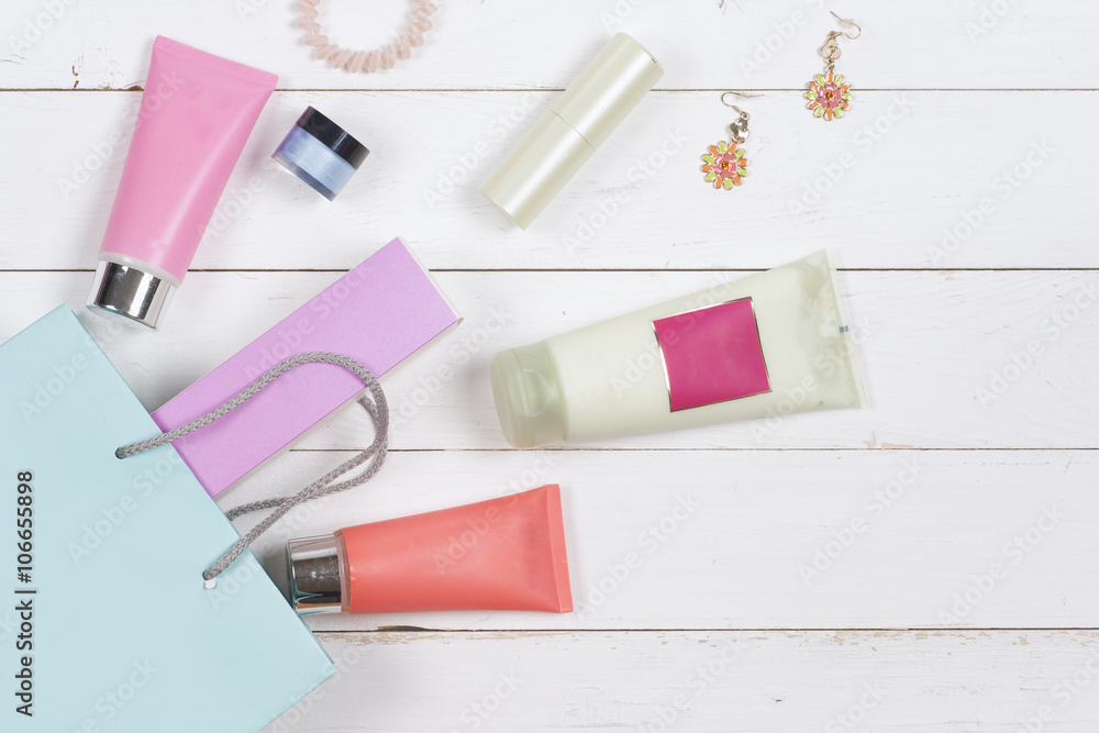 Woman's cosmetics and accessories on wooden background. Beautiful make up bag with cosmetics Woman's cosmetics and accessories on wooden background. Beautiful make up bag with cosmetics