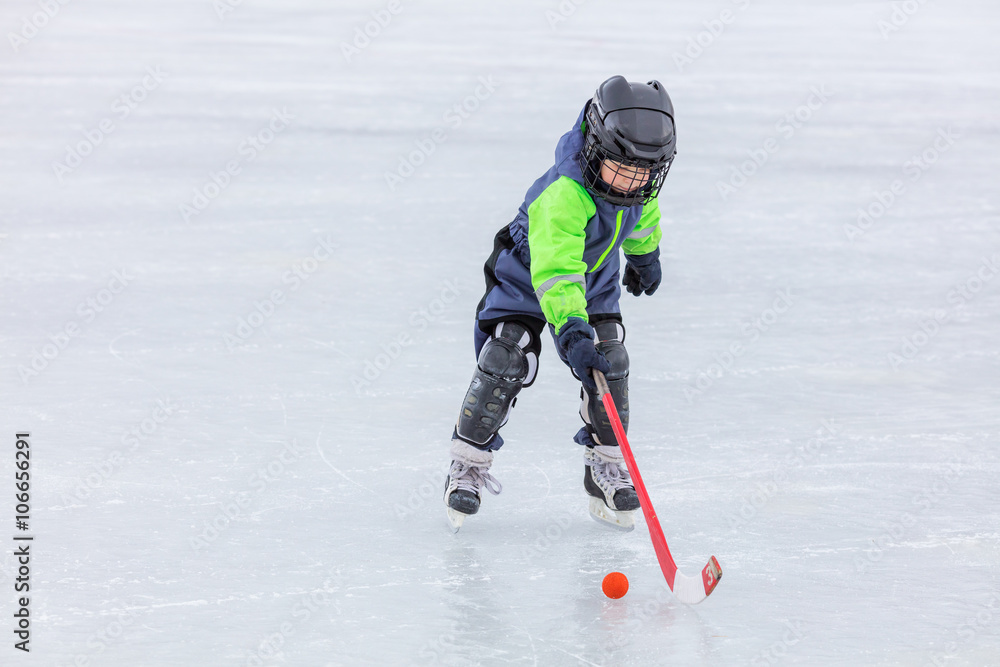 Little boy skating and playing hockey Little boy skating and playing hockey