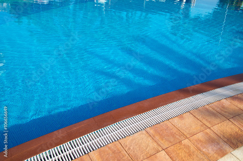 Blue pool water with sun reflections