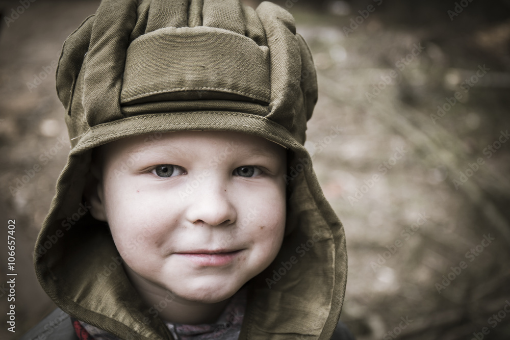Little boy in a tank helmet Little boy in a tank helmet