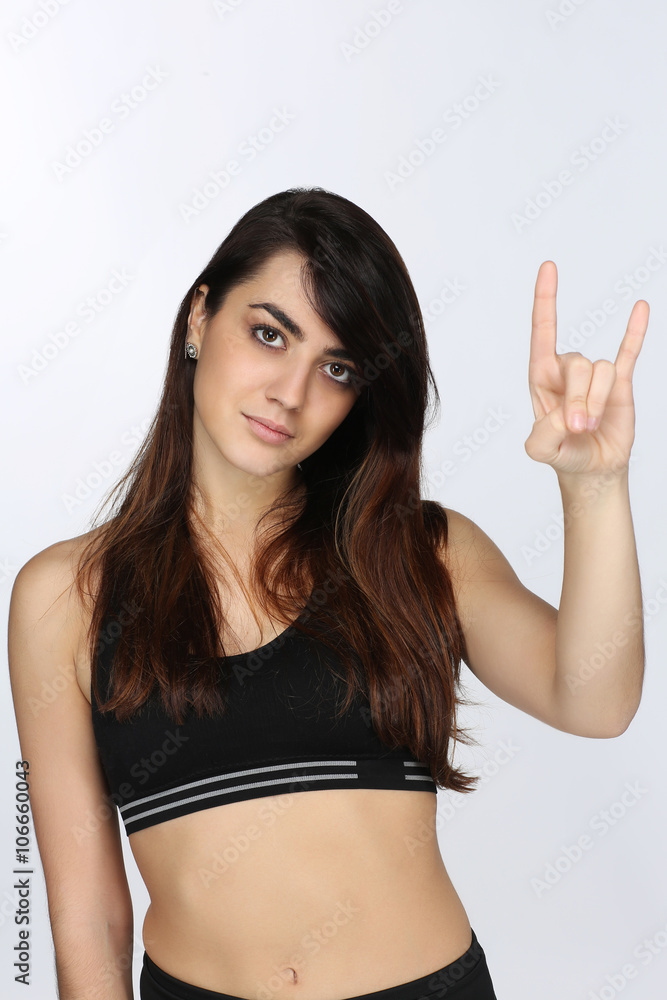 Portrait d'une jeune femme qui fait le signe Rock n'roll Portrait d'une jeune femme qui fait le signe Rock n'roll