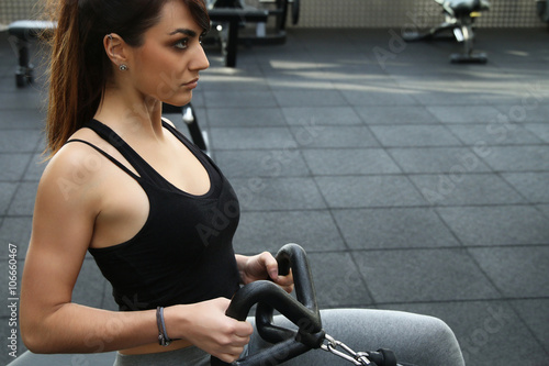 Muscular woman doing pulling exercises