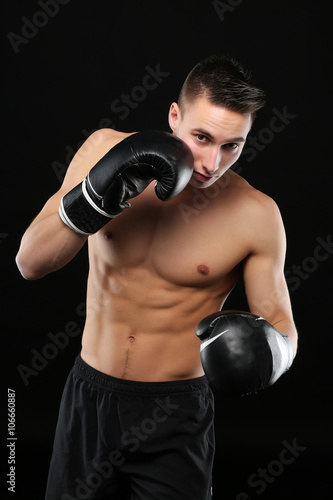 Shirtless man with boxe gloves training © eric