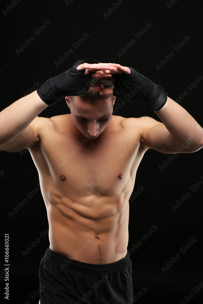 Young boxer training on dark background
Young boxer training on dark background
