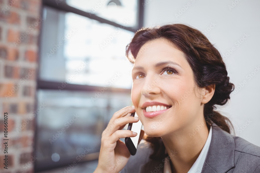 Young businesswoman talking on mobile phone Young businesswoman talking on mobile phone
