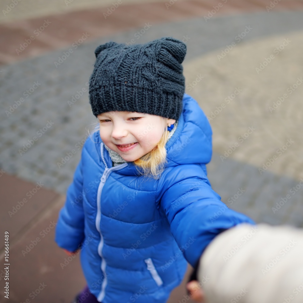 Cute little girl holding her mothers hand outdoors Cute little girl holding her mothers hand outdoors