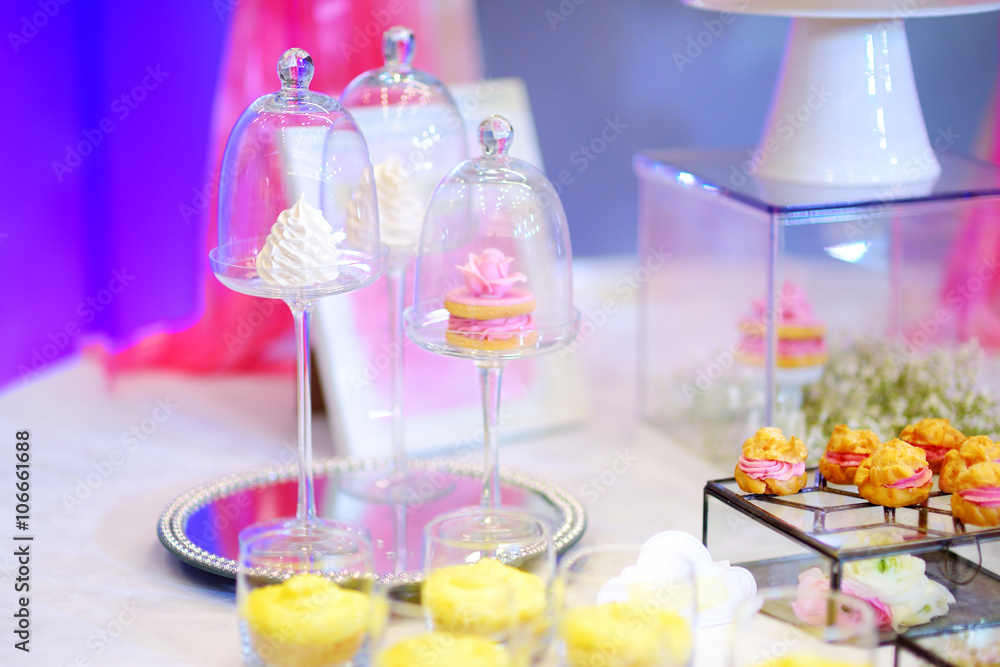 Beautiful desserts, sweets and candy table at wedding reception