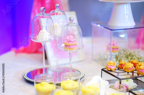 Beautiful desserts, sweets and candy table at wedding reception