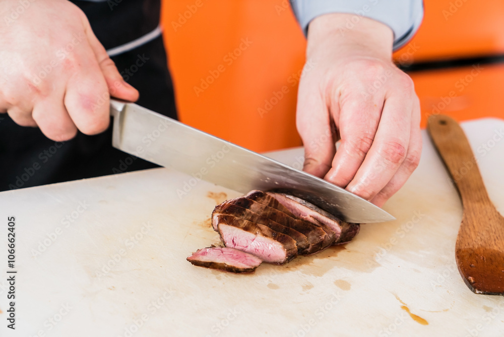 chef cutting steak