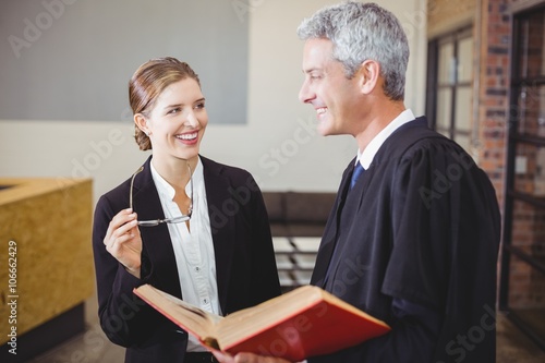 Happy Male lawyer standing by female colleague photo