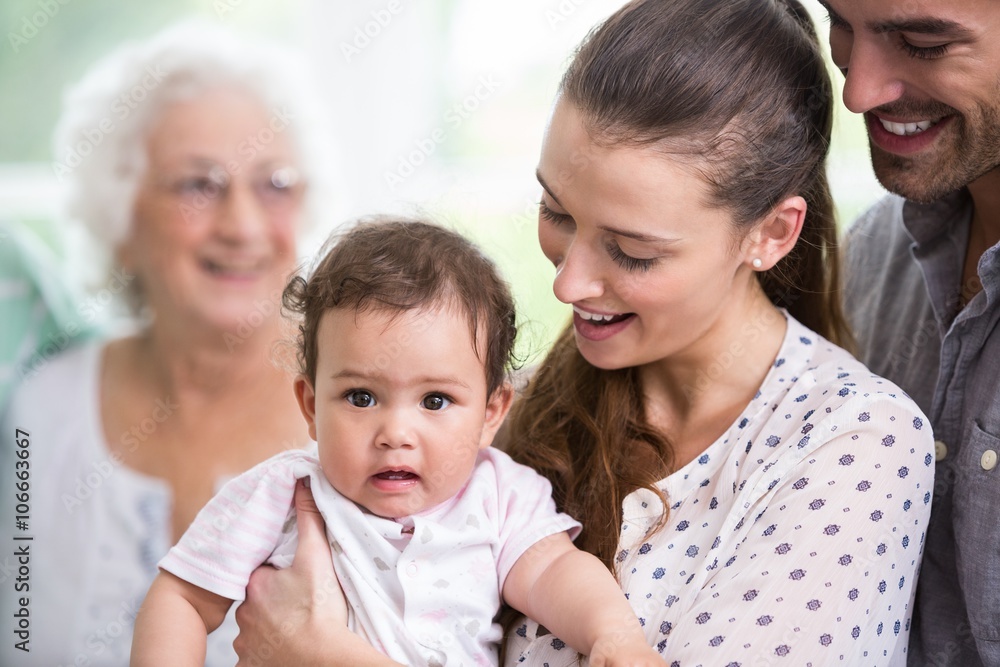 Smiling mother carrying cute baby with father Smiling mother carrying cute baby with father