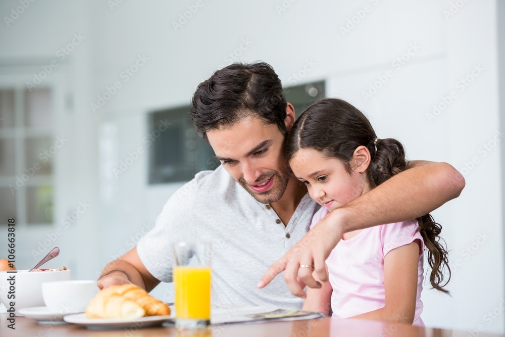 Father and daughter reading newspaper Father and daughter reading newspaper