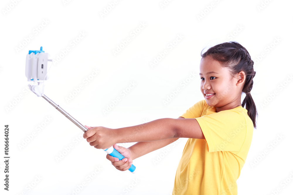 Portrait of young Asian girl with selfie stick isolated on white Portrait of young Asian girl with selfie stick isolated on white