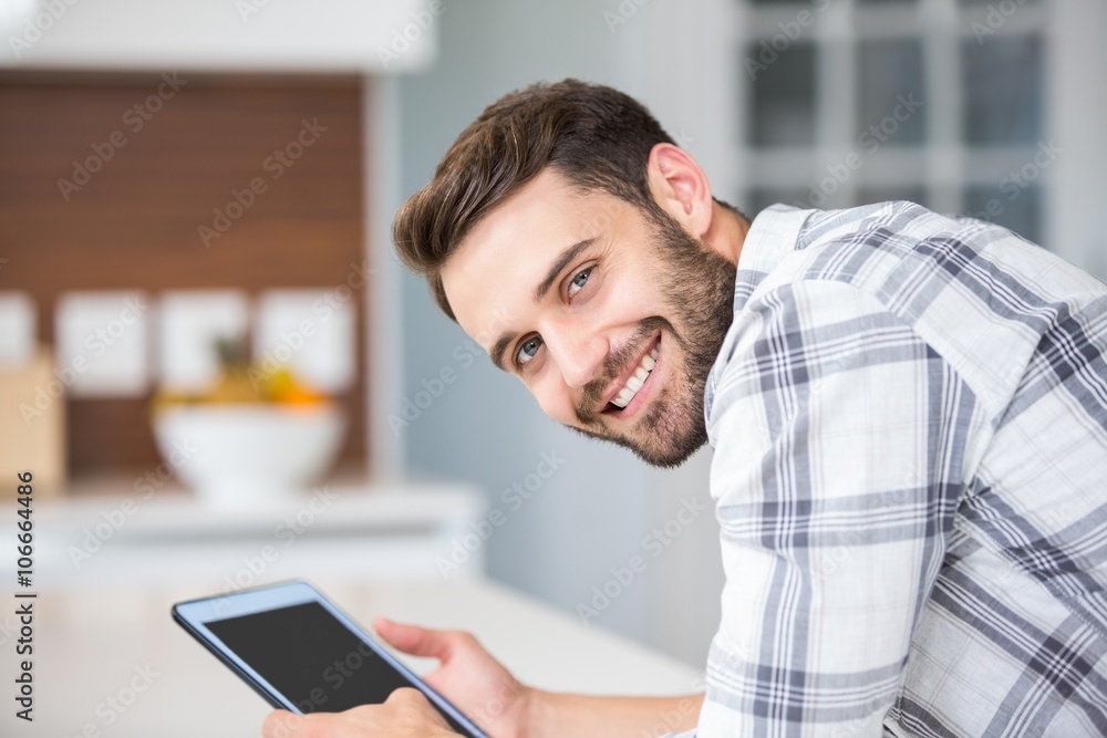 Happy young man using digital tablet 