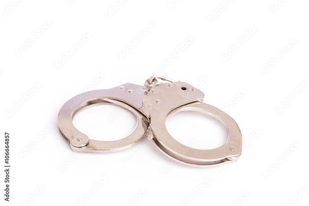 Close up silver handcuffs isolated on white Close up silver handcuffs isolated on white