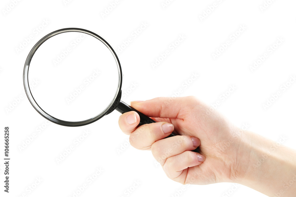 Female hand holding magnifying glass on a white background Female hand holding magnifying glass on a white background