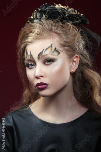 Beauty portrait of a passionate sexy woman with fancy make-up on a dark background