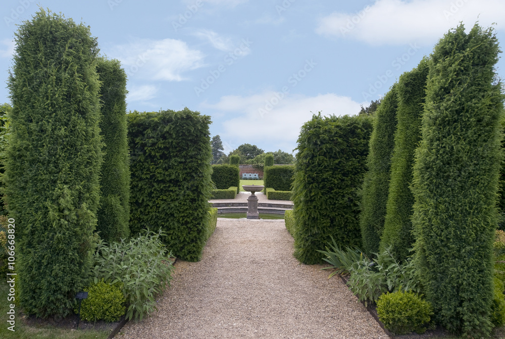 Avenue of trees leading to Fountain in pool English Formal Garden