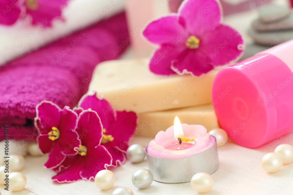 SPA setting with candles and fresh violets