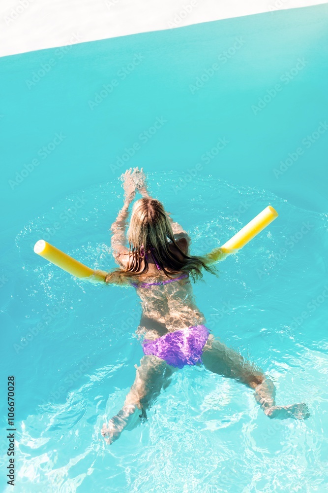 Woman swimming in swimming pool