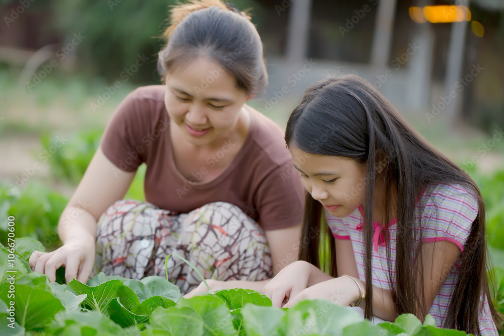 Happy Asian daughter gardening with her mother