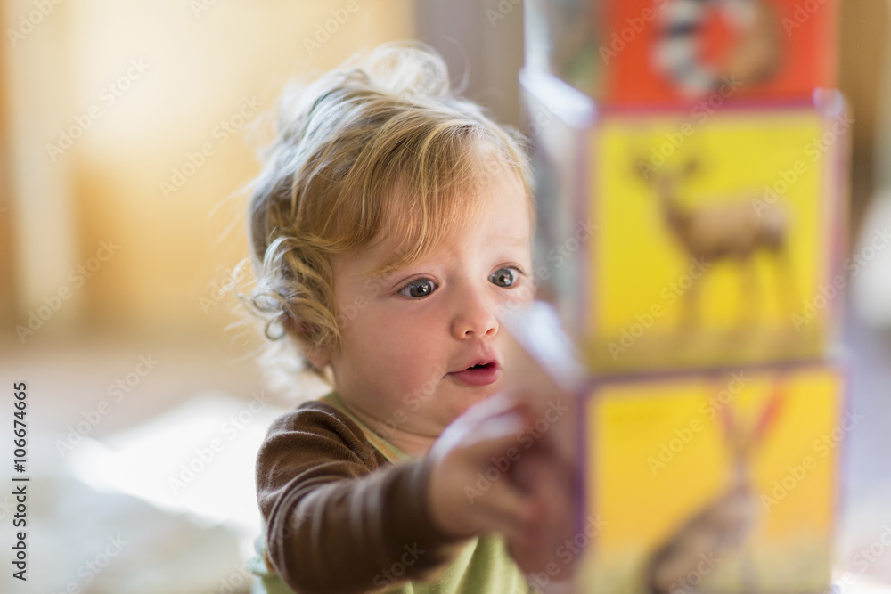 Caucasian baby boy stacking colorful blocks Caucasian baby boy stacking colorful blocks