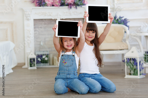 two little girls with tablet computer