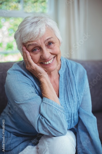 Happy senior woman sitting on sofa 