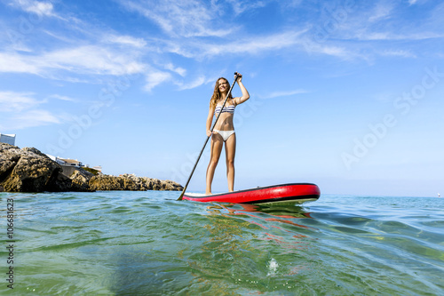 Woman practicing paddle © ikostudio