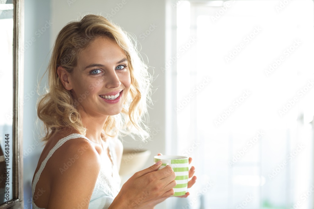 Happy young woman having coffee at home Happy young woman having coffee at home